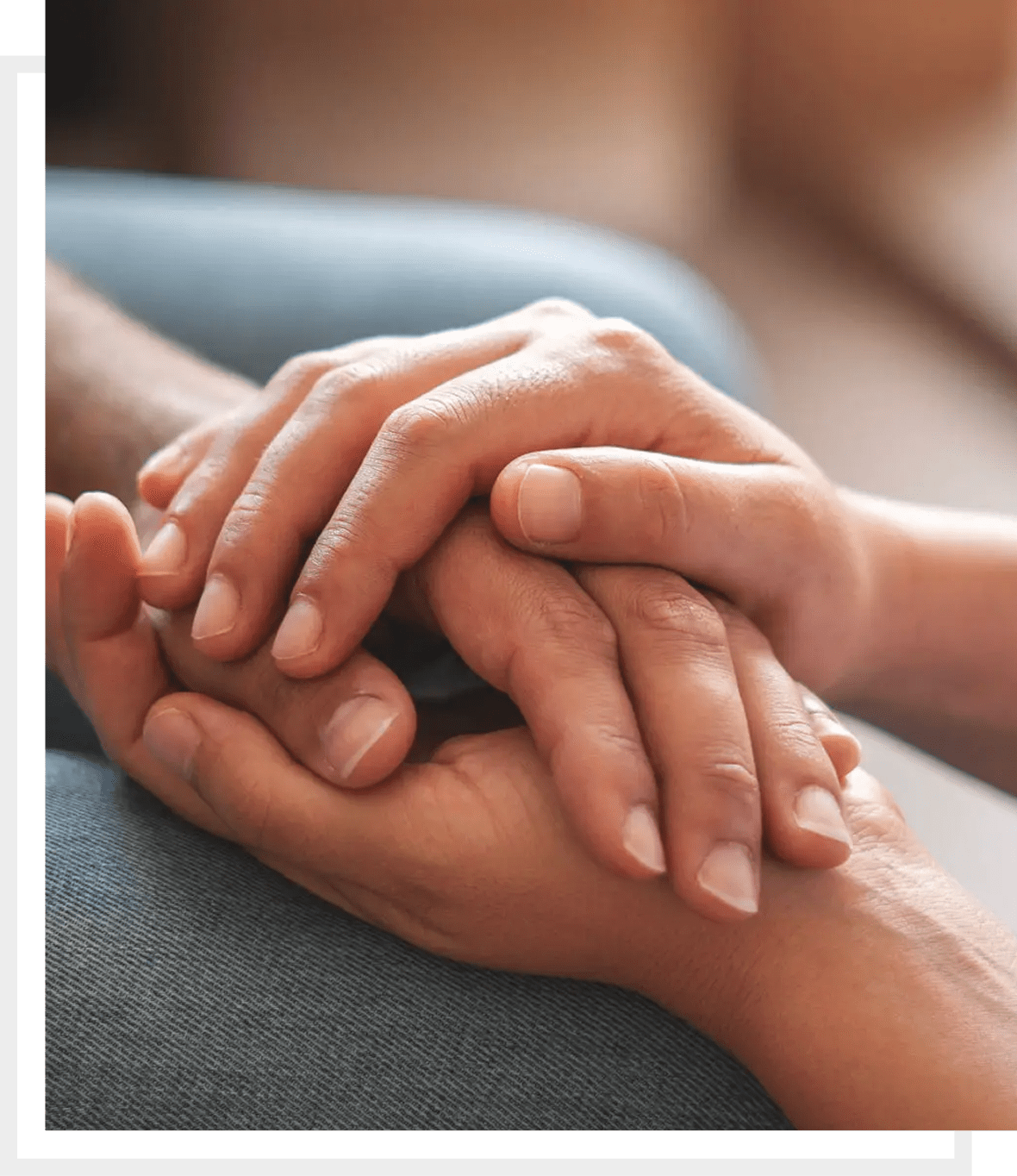 Two people holding hands, symbolizing support and care.