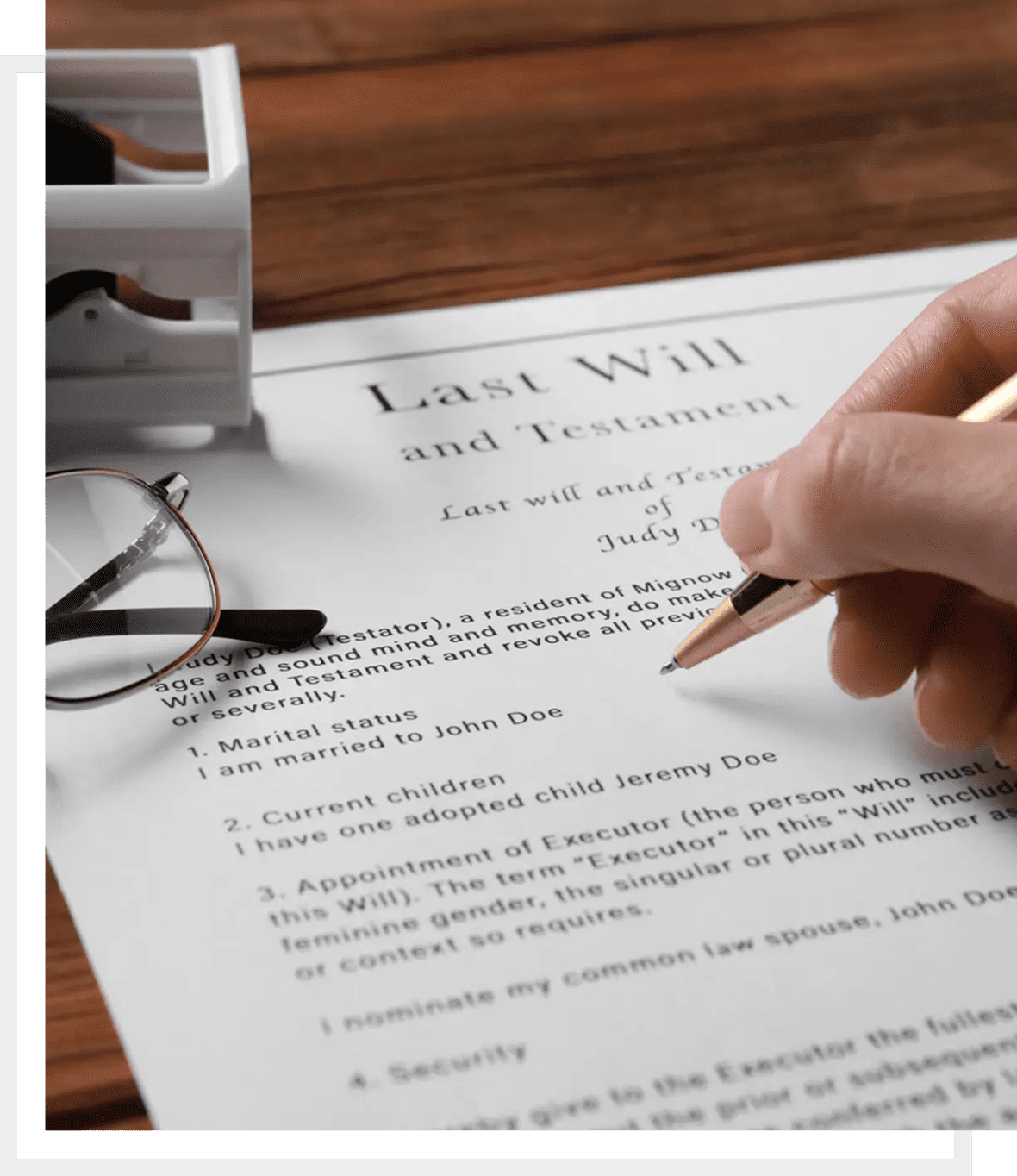 Person signing a last will and testament document.