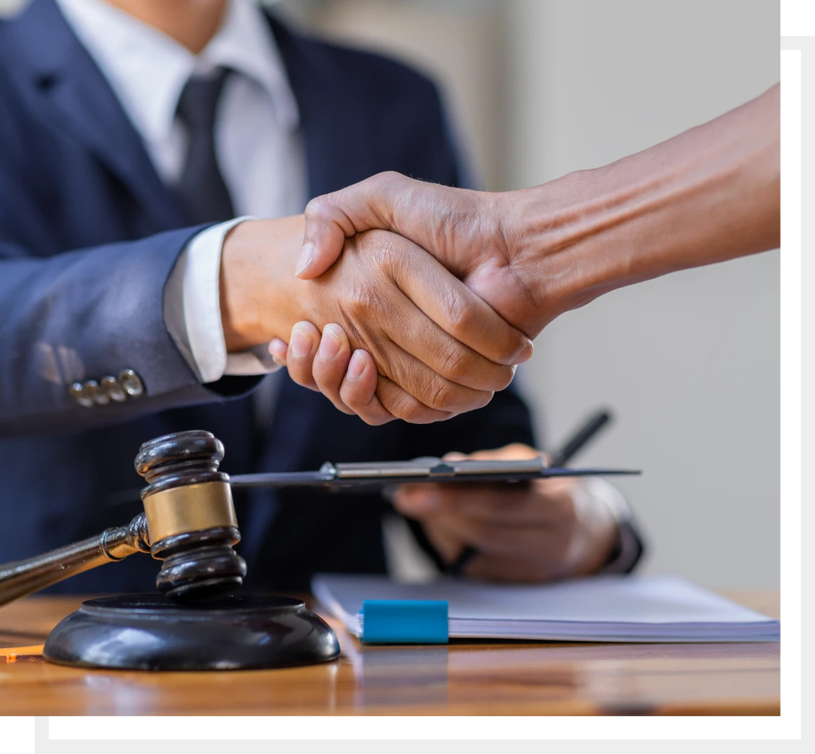 Business agreement handshake with gavel nearby
