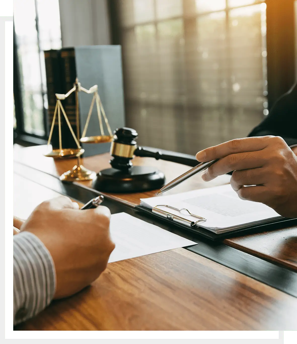 two people with pen in their hands pointing out to a document